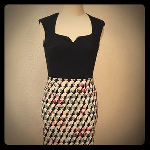 Knee length skirt and black sweetheart tank top.