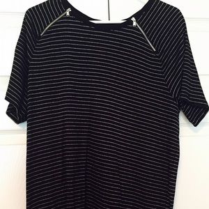 Black top with silver stripe and zipper detail.