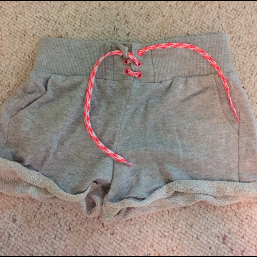 Rolled up grey shorts with pink tie