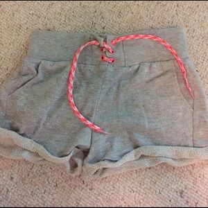 Rolled up grey shorts with pink tie