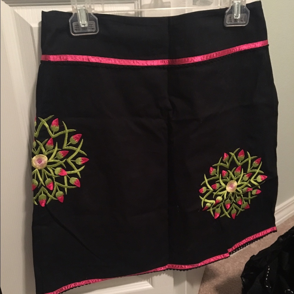 black skirt with hot pink embroidered flowers