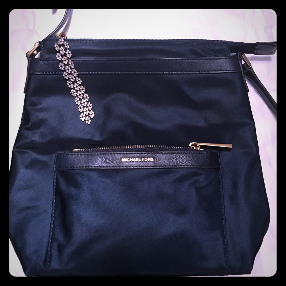 Michael Kors navy blue purse with gold trim.