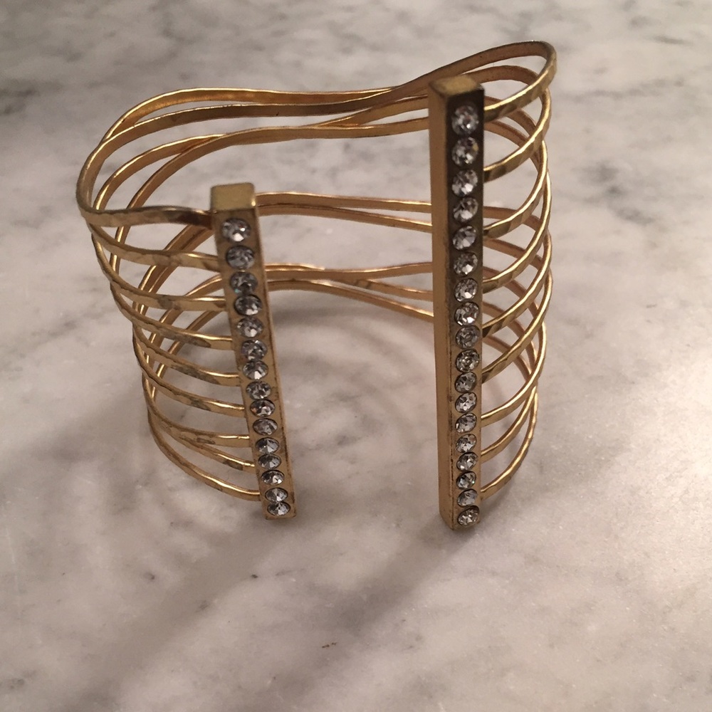 A gold cuff bracelet with crystals