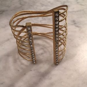 A gold cuff bracelet with crystals