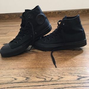 Converse Chuck Taylor all black high tops.