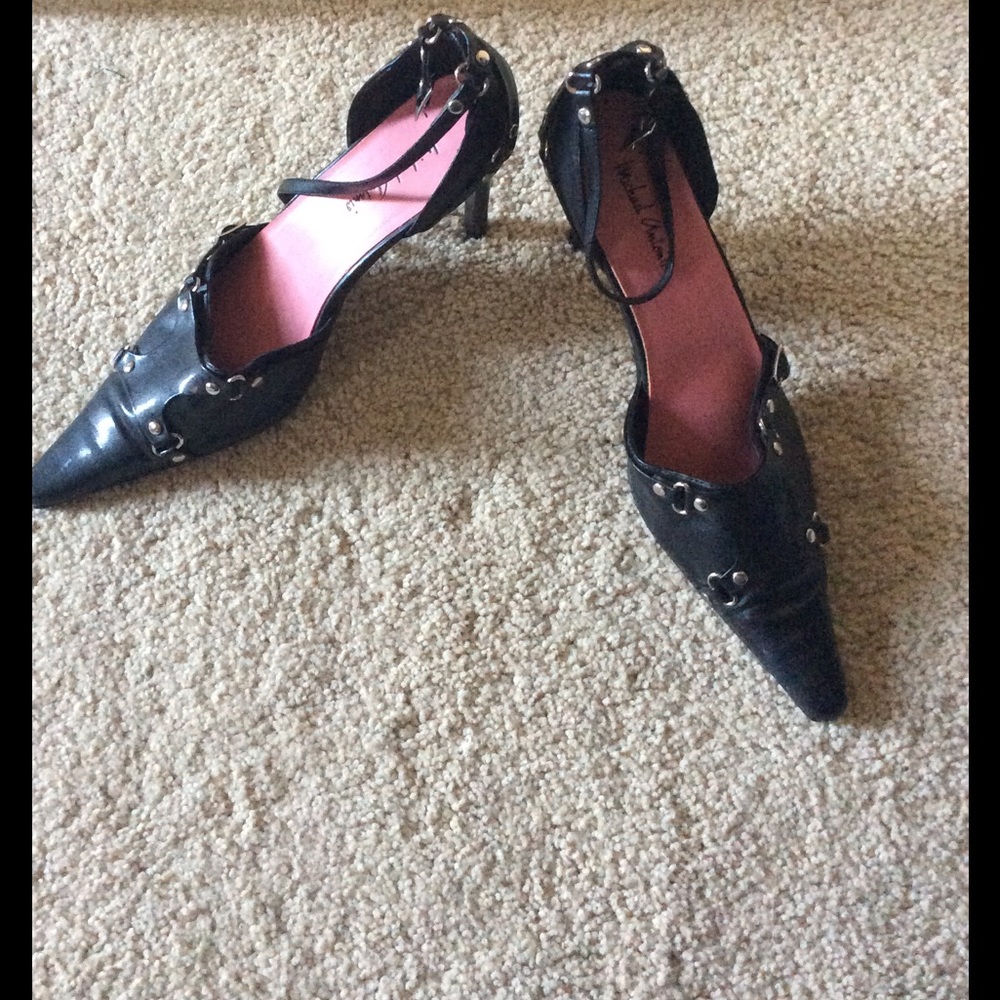 Black ankle strap heels with metal grommets.