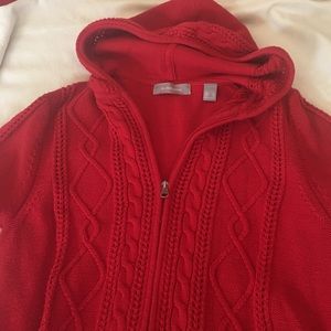 Stylish red sweater with woven hood.