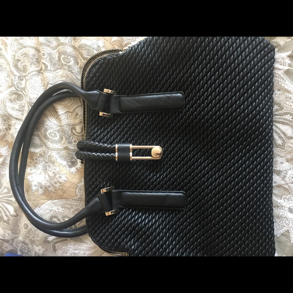 Black bag with twisted detail and gold accents