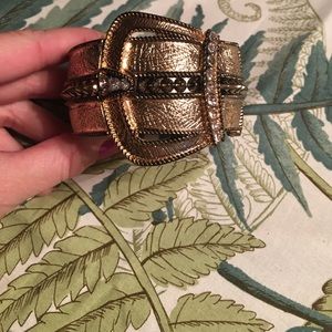 Gold colored bangle with faux buckle detail