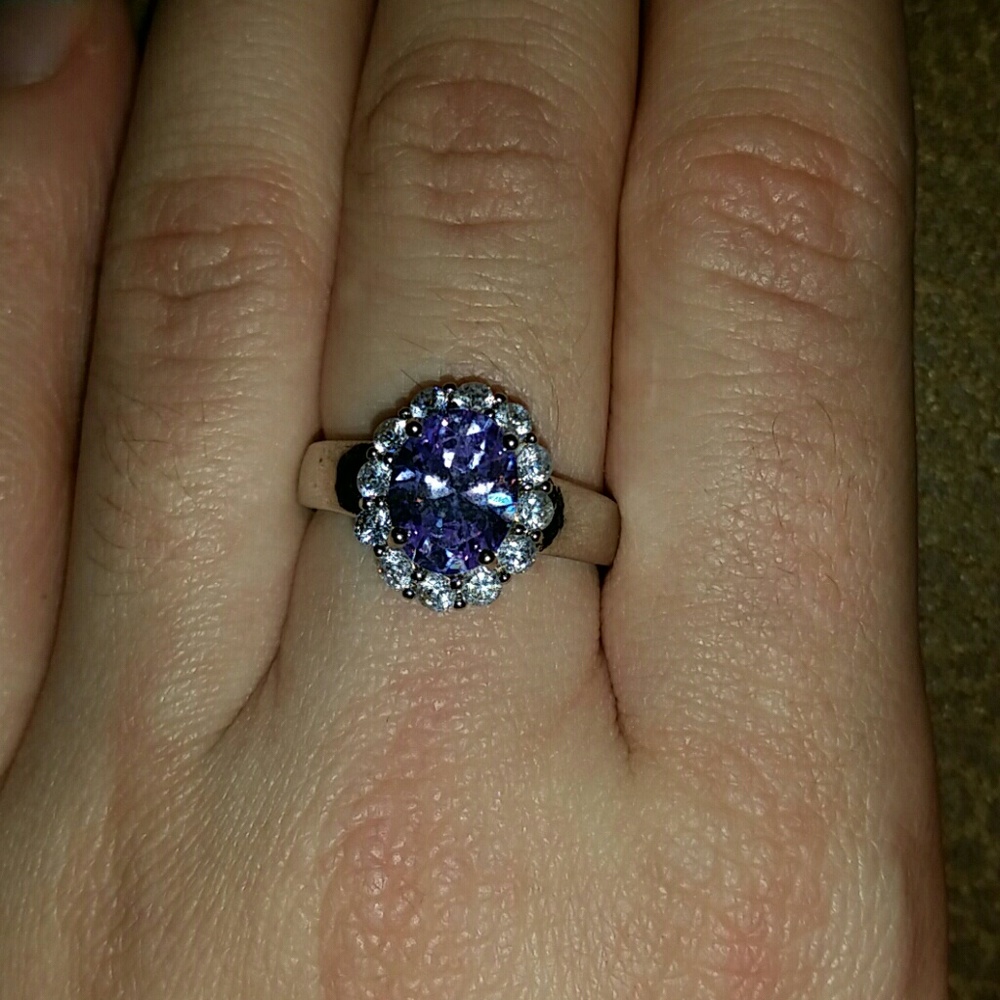 Pastel purple gem surrounded my diamonds. Silver