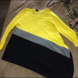 3/4 length black, grey and yellow angled shirt.