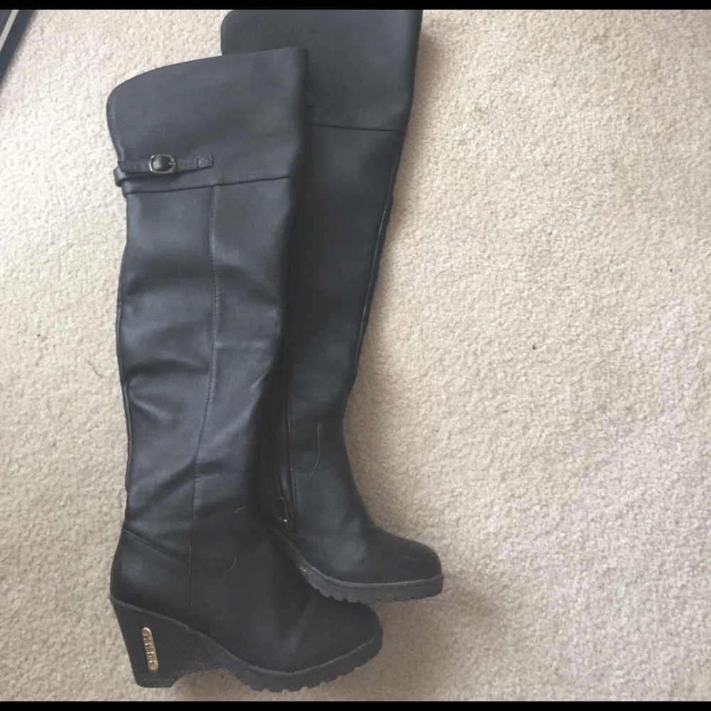 Black leather wedge thigh high boots.