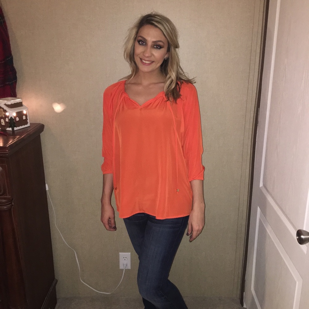 Bright orange Michael Kors top.