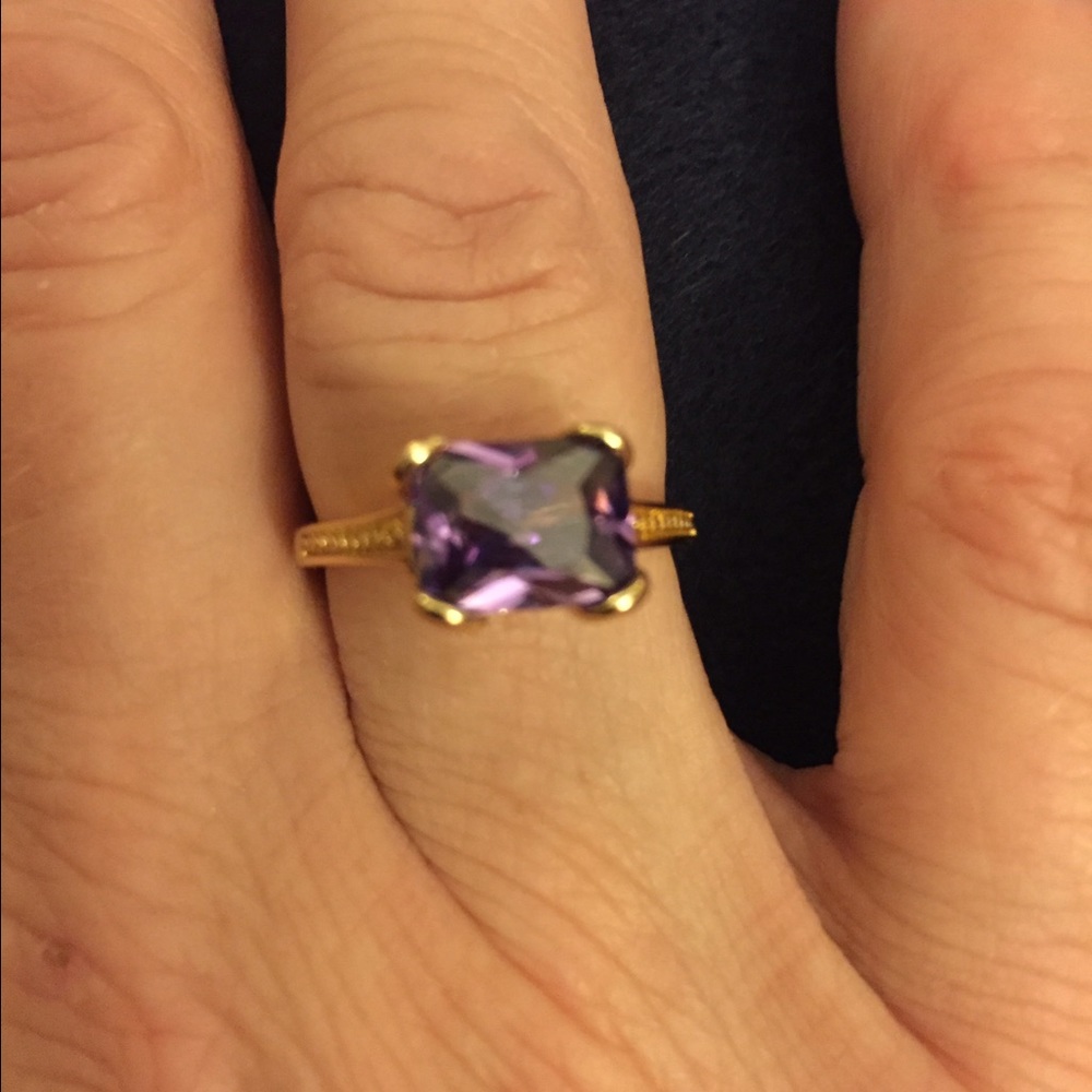 Cute gold tone stacker ring with purple stone.
