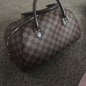 Authentic Louis Vuitton Damier printed handbag.