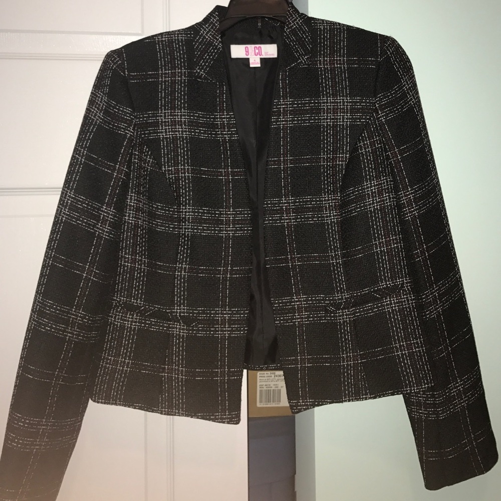 Black jacket with white and red stitching.