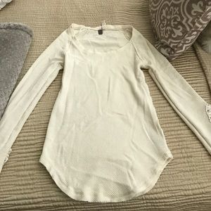 Long sleeve shirt w/ lace on bottom of sleeves.