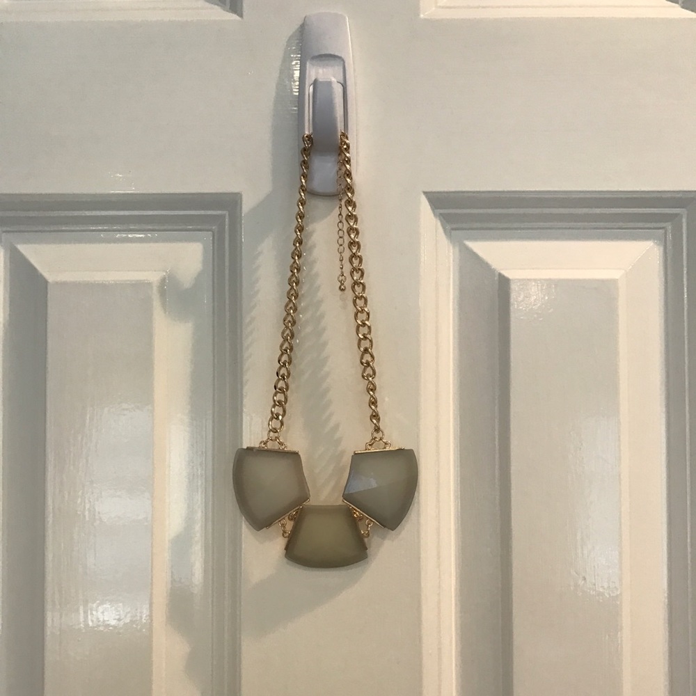 Gold chain necklace with 3 gray gem pendants.