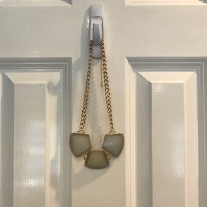 Gold chain necklace with 3 gray gem pendants.
