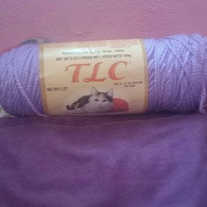 pink & white bag with 2 rolls of yarn