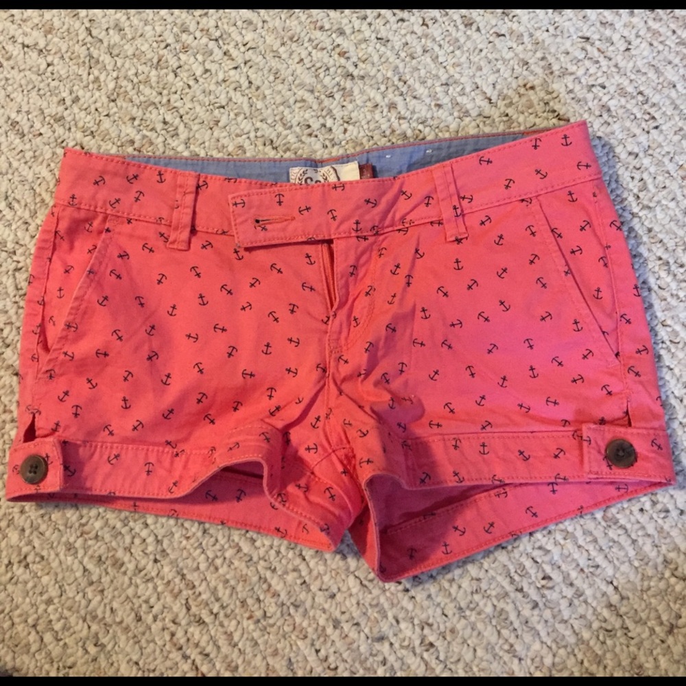 Salmon colored shorts with anchors on them