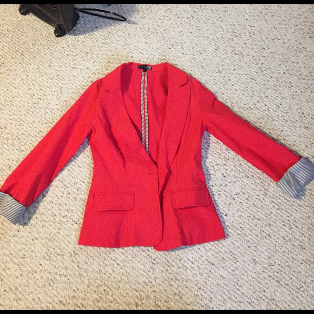 Red blazer with blue and white striped cuffs