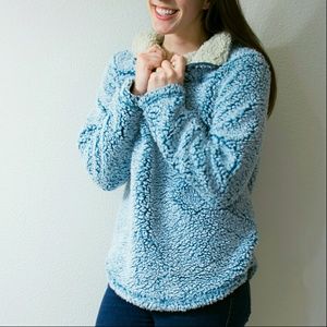 Frosty tipped, blue pullover.