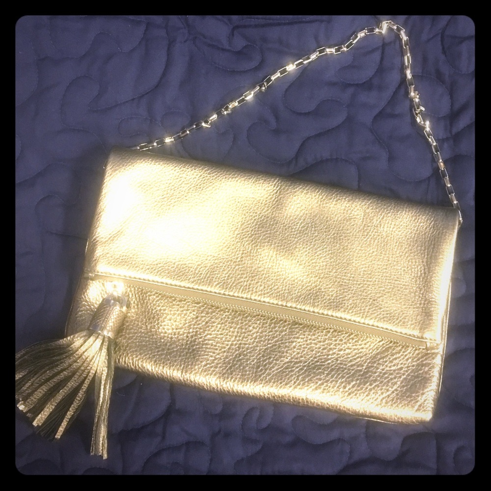 Micheal Kors fold over gold clutch. Calf leather