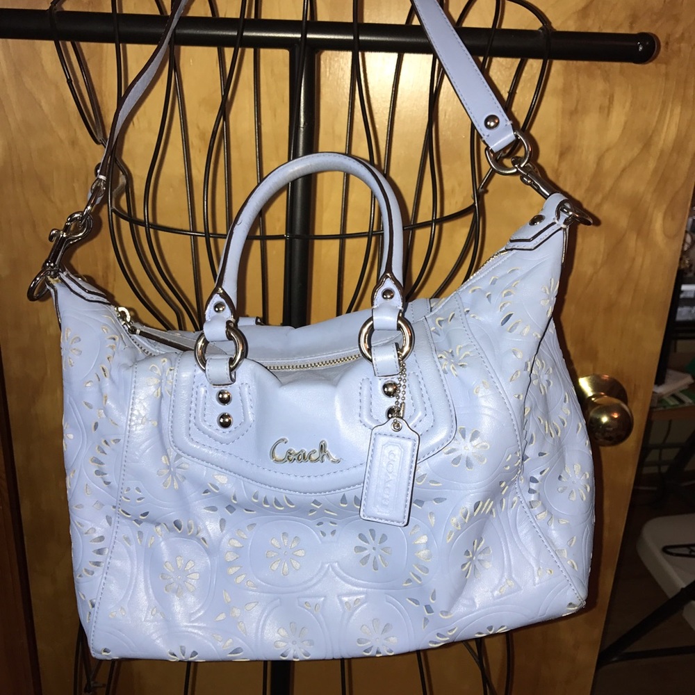 Light blue leather coach bag with flower design