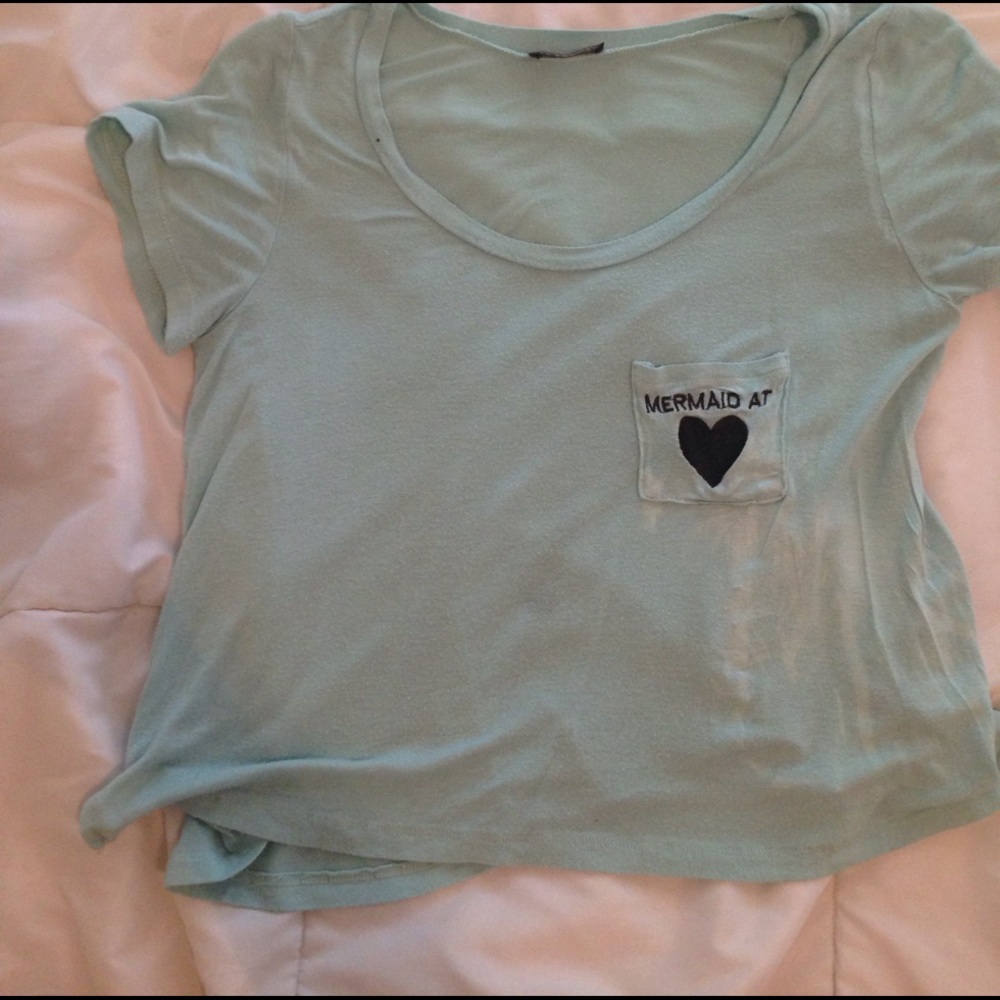 Light blue shirt with black writing and heart