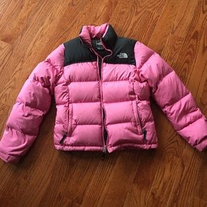Women's pink and black puffy North Face coat.