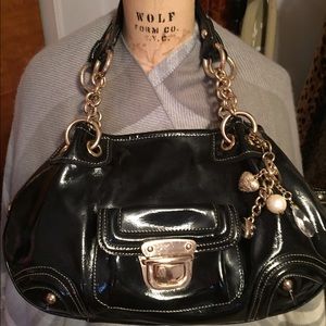 Black handbag with gold chains and hanging jewels