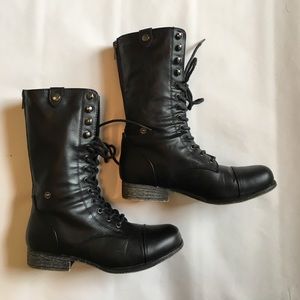 Black combat boots with blue zippers