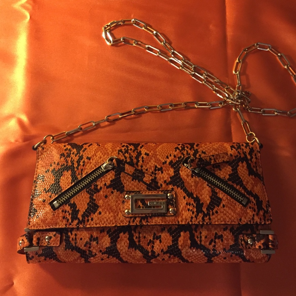 Orange clutch by Guess