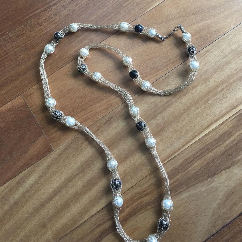 Long faux pearl necklace with gold colored wire