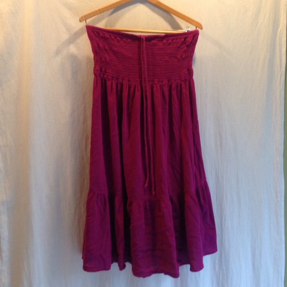 Raspberry colored strapless dress.
