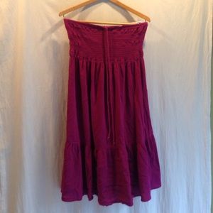 Raspberry colored strapless dress.
