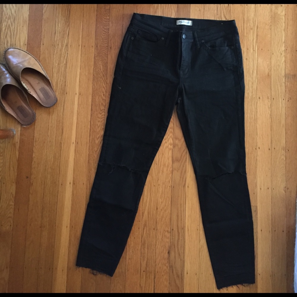 Raw hem black skinny jeans with rips in knees