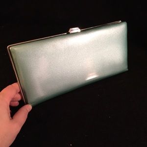 Sleek metallic mint green wallet/clutch.