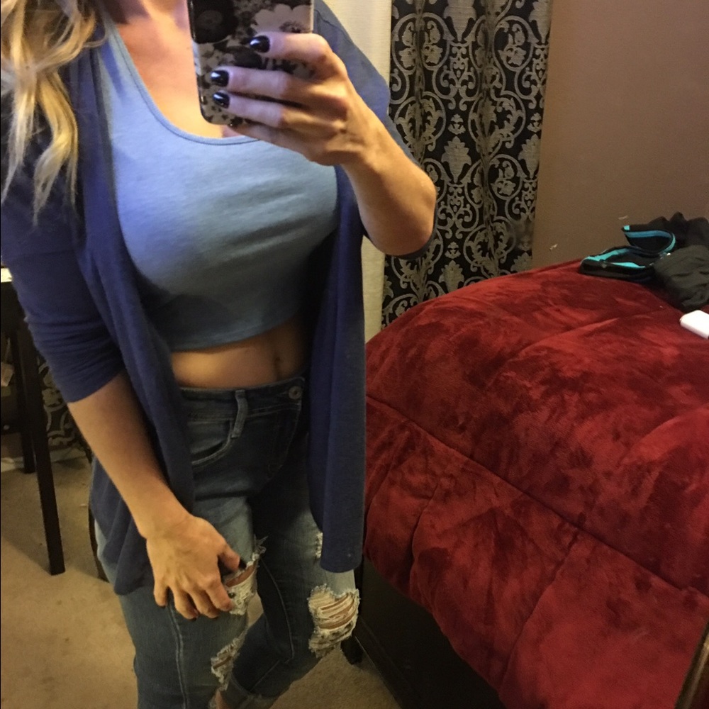 Blue cardigan and light blue halter-crop top.