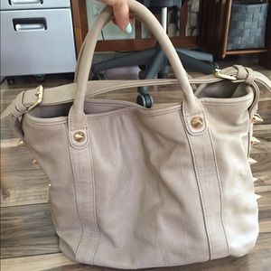 Light-tan handbag with gold spikes
