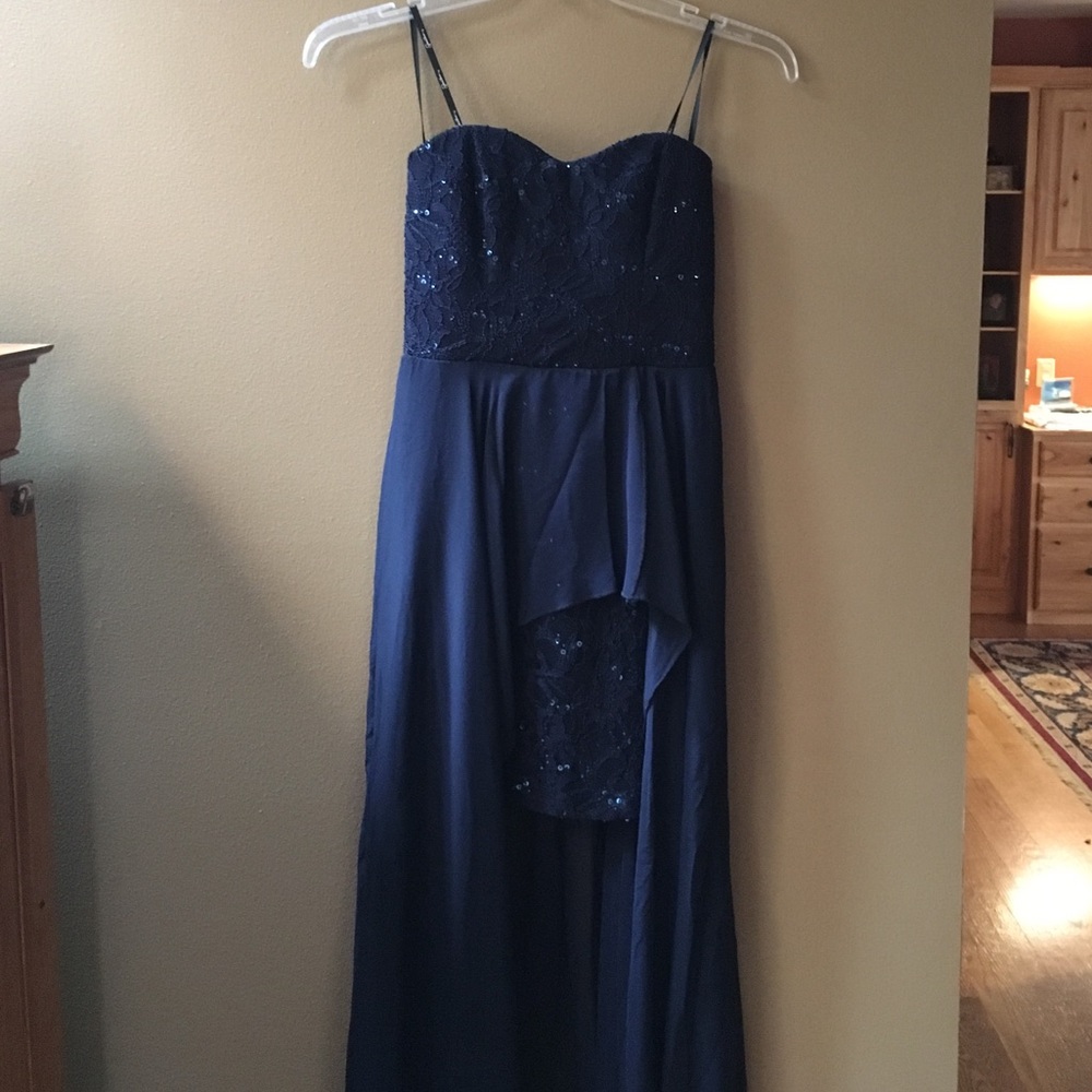 This navy blue strapless gown has never been worn