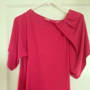 Anne Klein top with one flutter short sleeve.