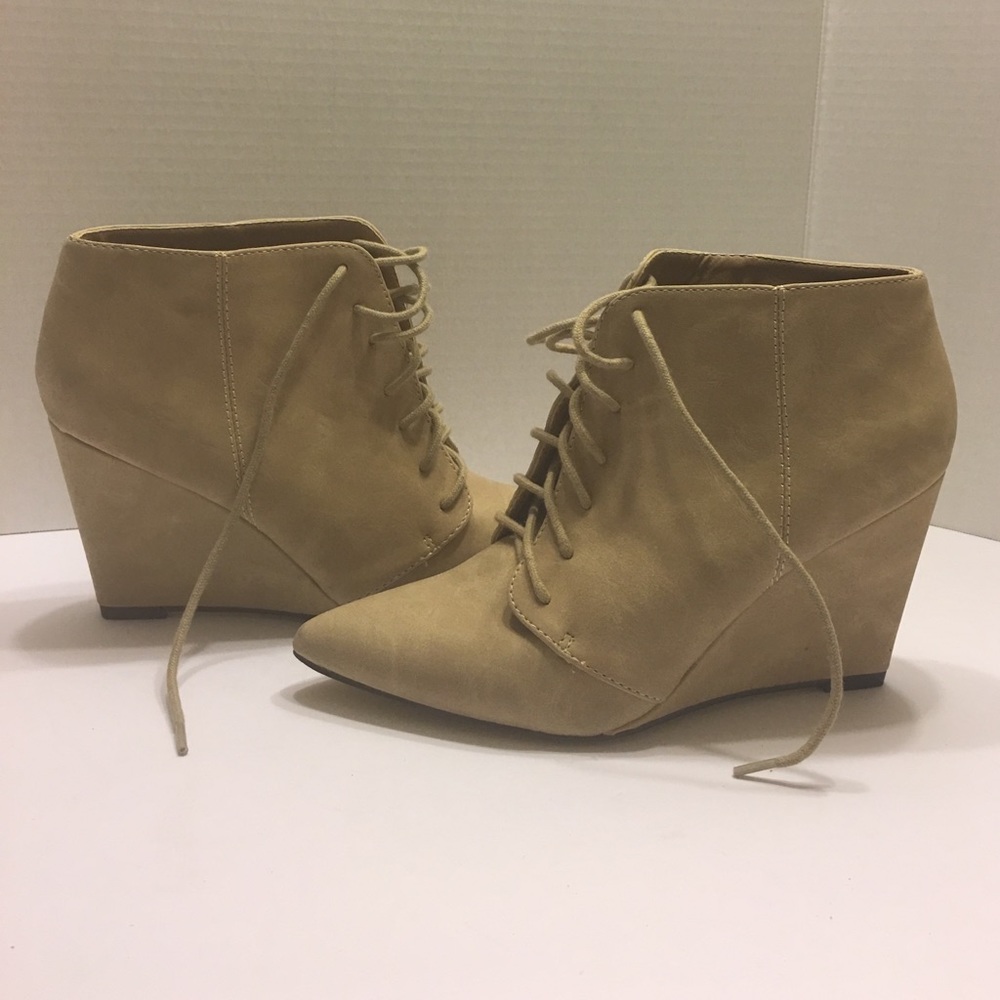 Tan wedge lace up booties.