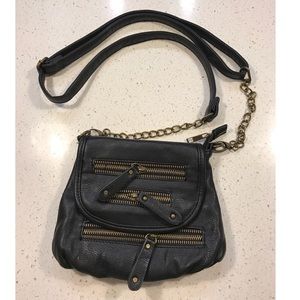 Black cross body purse with gold zippers