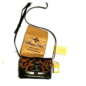 Adjustable groovy cross body leopard print purse.