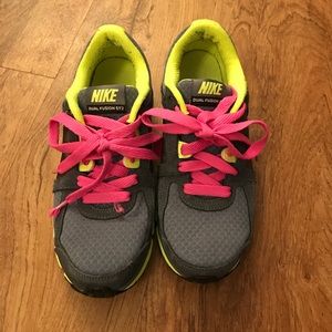 Neon Nike women's athletic shoes.