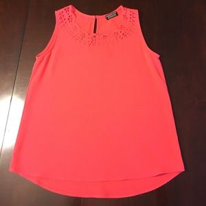 Coral sleeveless blouse.