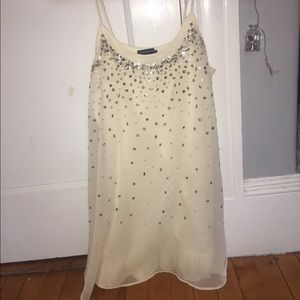 Short, white dress with different beads