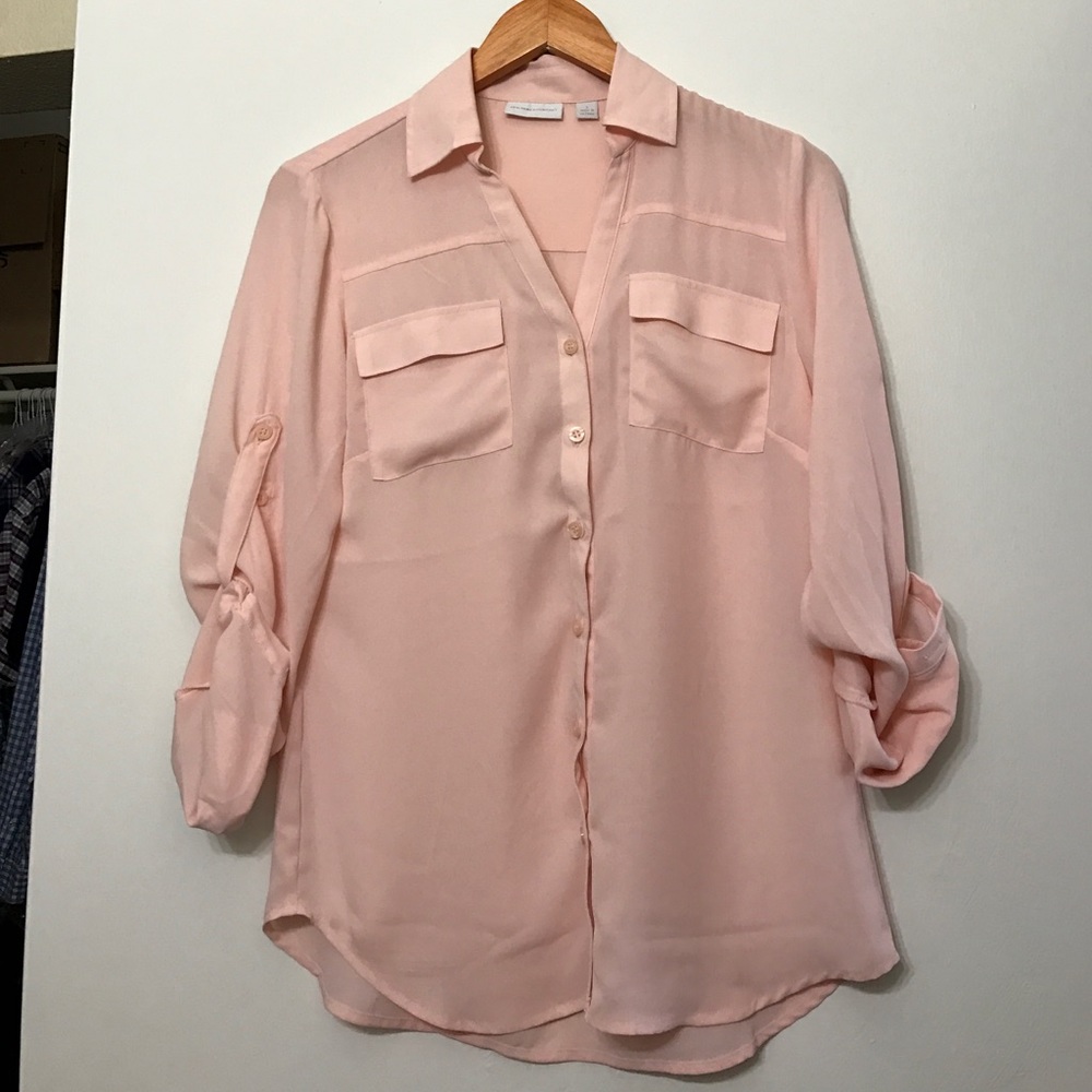 Pale pink button up blouse.